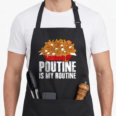 Poutine canadian aprons - Cartoon basket of poutine with white text POUTINE IS MY ROUTINE below — shown on a black cotton canvas apron against a white background