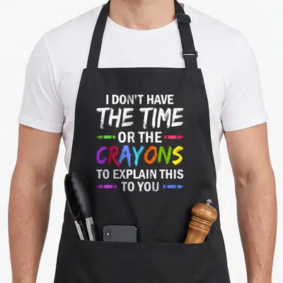 Explain apron or apron - Stacked white text reading I DON'T HAVE THE TIME OR THE CRAYONS TO EXPLAIN THIS TO YOU — shown on a black cotton canvas apron against a white background
