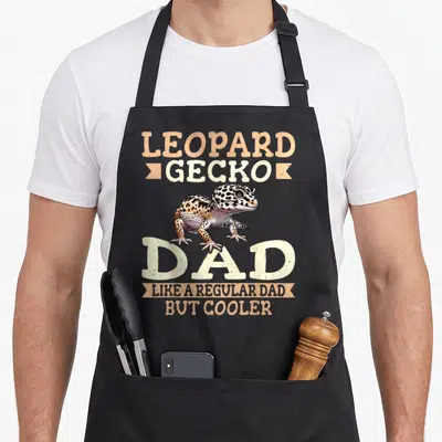 Gecko leopard apron for women - Leopard gecko illustration surrounded by distressed text reading dad like a regular dad — shown on a black cotton canvas apron against a white background