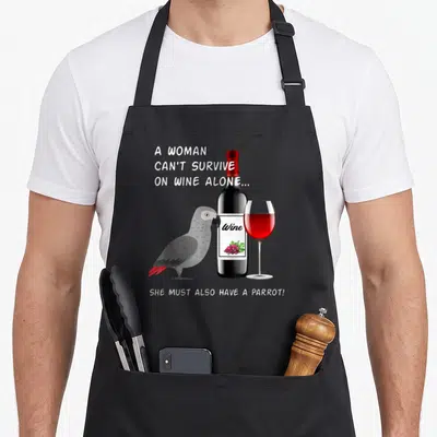 Wine african aprons - Grey parrot with red tail next to wine bottle and glass with white text on grey background — shown on a black cotton canvas apron against a white background