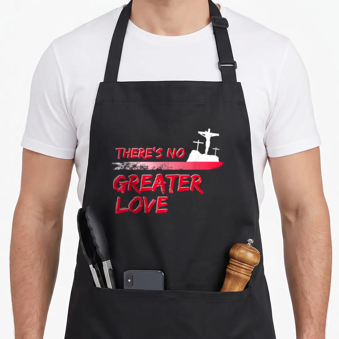 Greater easter apron - Red text There's No Greater Love separated by brushstroke next to white silhouette of three — shown on a black cotton canvas apron against a white background