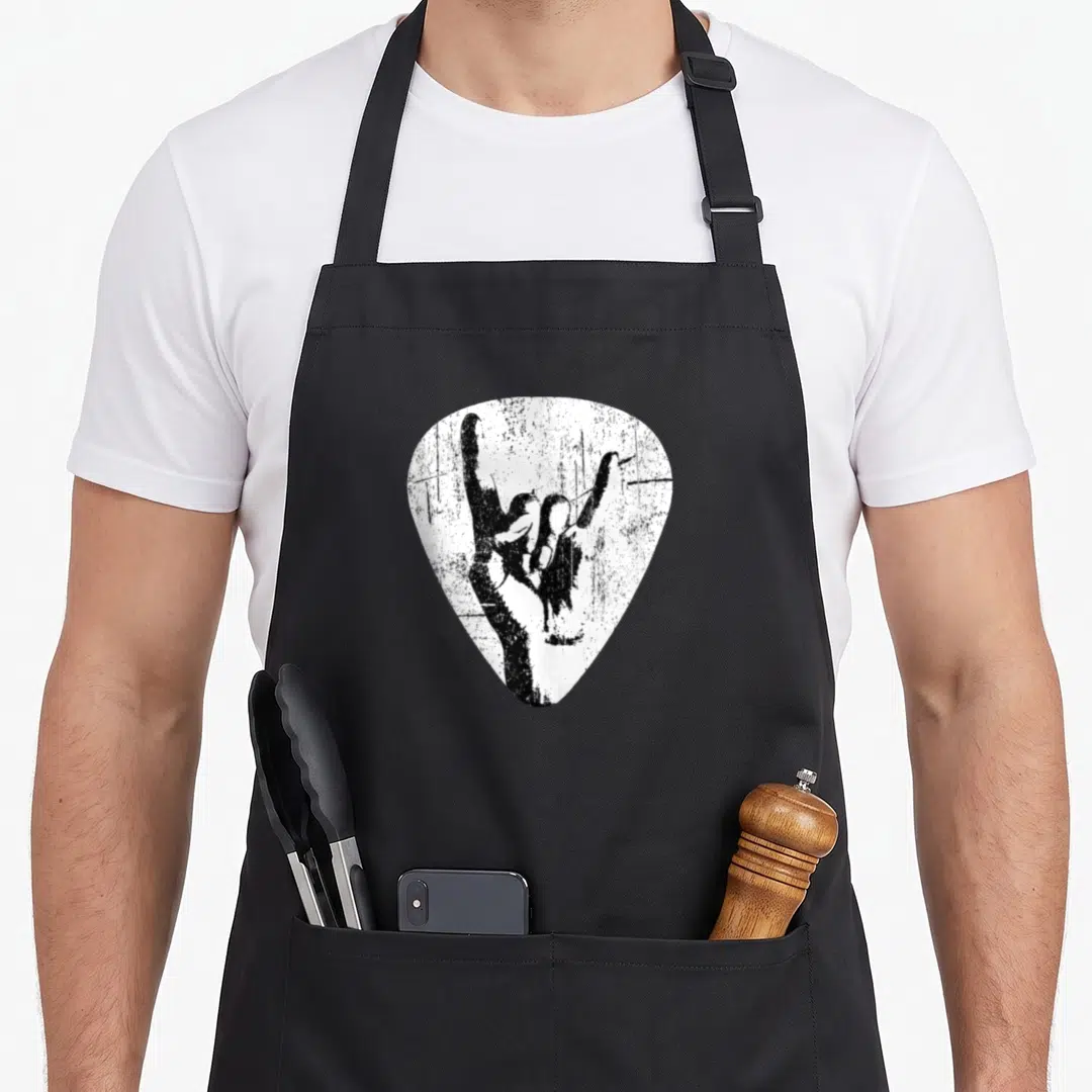 Hand punk rock apron - Distressed black hand sign inside white guitar pick shape — shown on a black cotton canvas apron against a white background