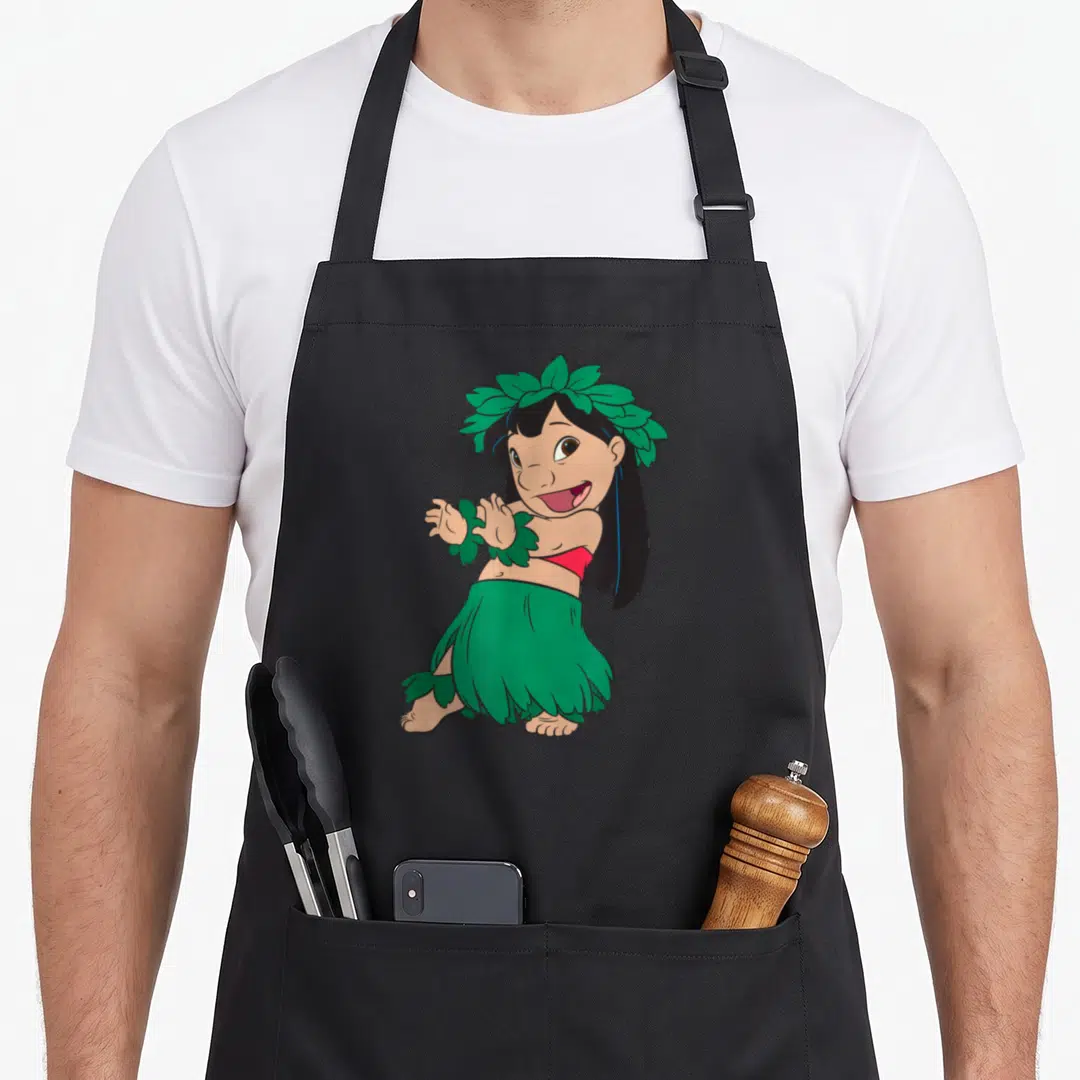 Hula dance apron - Cartoon girl wearing green leaf skirt, headpiece, and wrist cuffs with red top — shown on a black cotton canvas apron against a white background