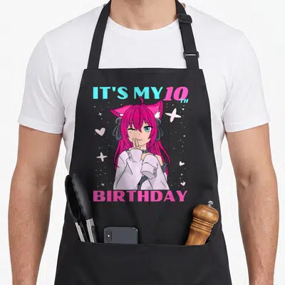 10th birthday anime mom apron - Anime girl with pink hair and IT'S MY 10TH BIRTHDAY text surrounded by hearts and stars — shown on a black cotton canvas apron against a white background
