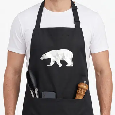 Bear christmas apron - White and grey geometric polar bear composed of triangles and diamonds on a grey background — shown on a black cotton canvas apron against a white background