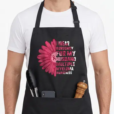 Multiple husband apron - Split burgundy flower with stacked text I Wear Burgundy For My Husband Multiple Myeloma — shown on a black cotton canvas apron against a white background