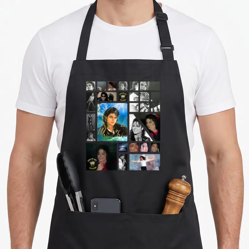 Funny jackson michaels apron - Collage of Michael Jackson photos with KING OF POP text and crown logo — shown on a black cotton canvas apron against a white background