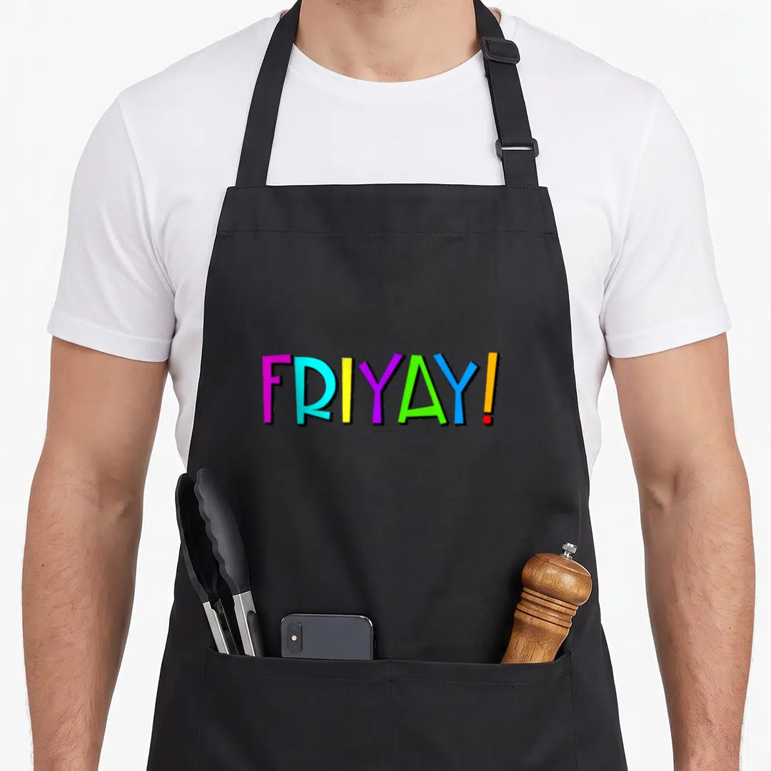 Cute friday friyay apron - FRIYAY! text in pink blue yellow purple green and orange — shown on a black cotton canvas apron against a white background