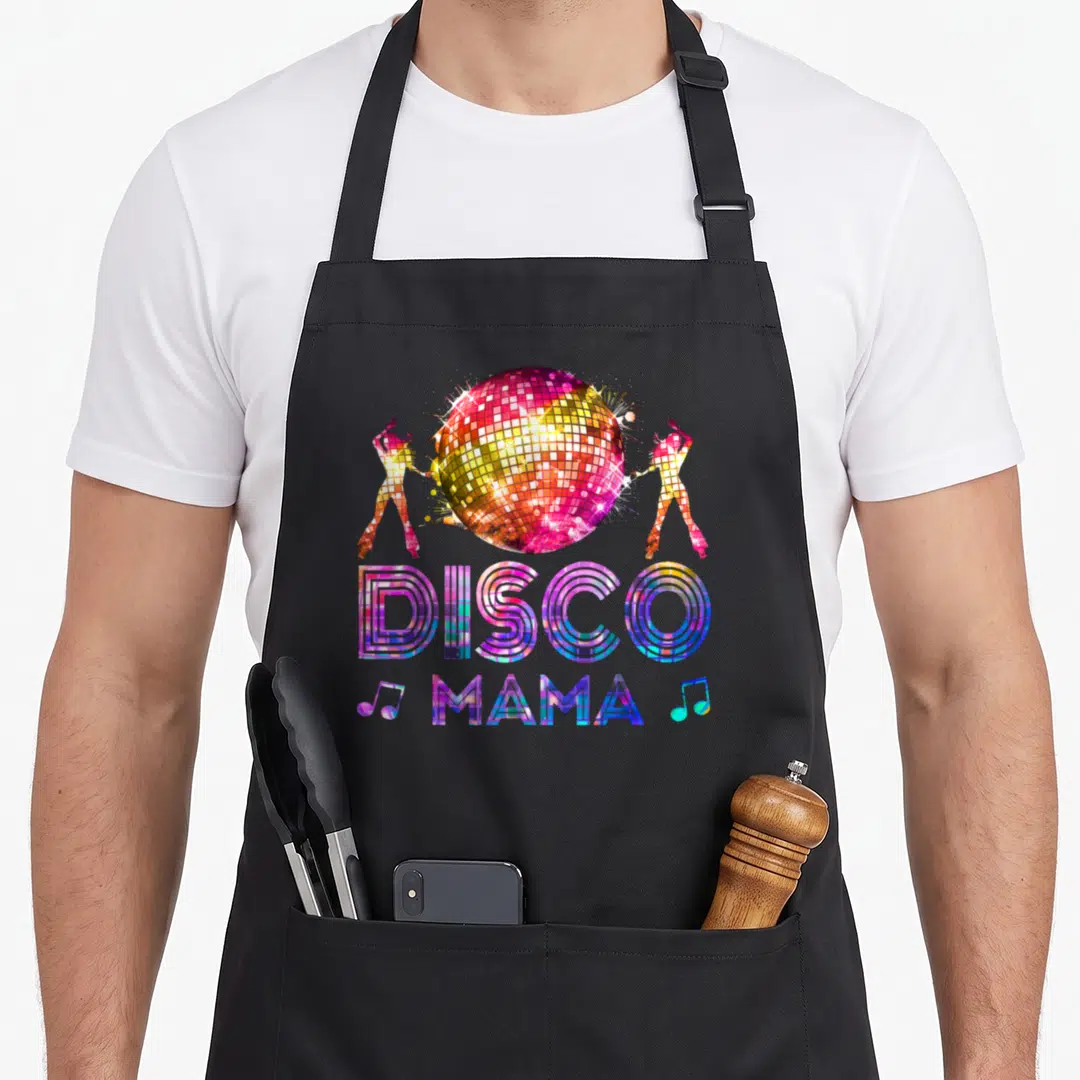 Disco mama apron - Colorful disco ball with two dancers and stacked DISCO MAMA text surrounded by musical notes — shown on a black cotton canvas apron against a white background
