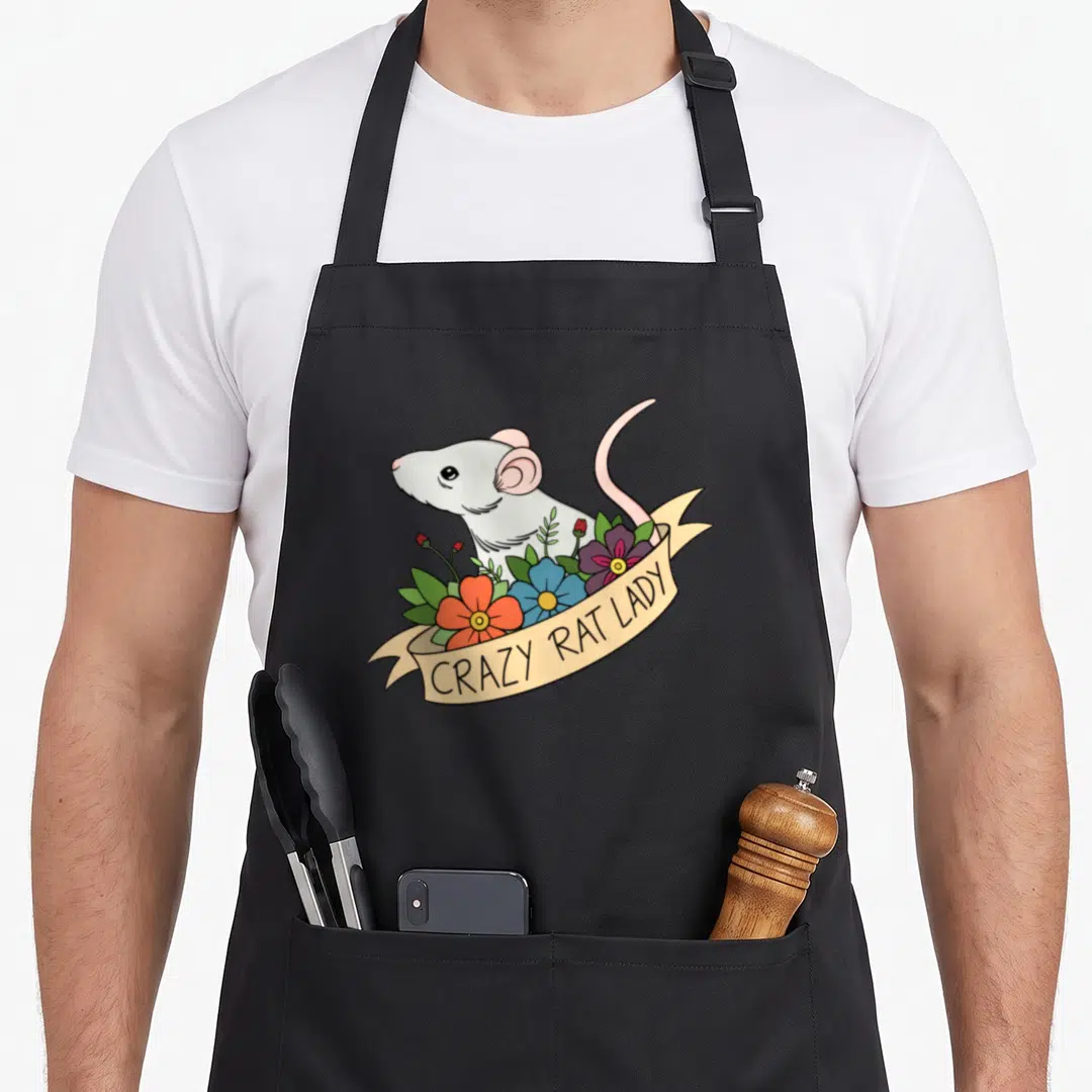 Rat flower pet apron - White rat behind orange blue and purple flowers with CRAZY RAT LADY banner — shown on a black cotton canvas apron against a white background