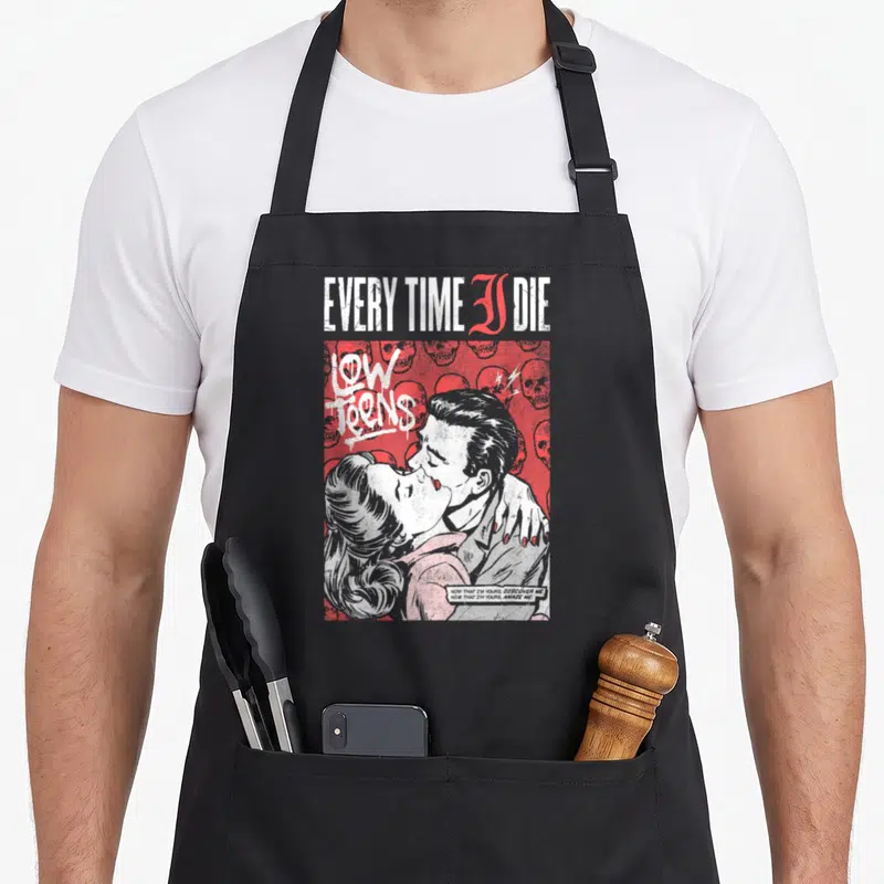 Embrace child expires apron - Every Time I Die Low Teens logo with kissing couple and skull pattern in red white — shown on a black cotton canvas apron against a white background