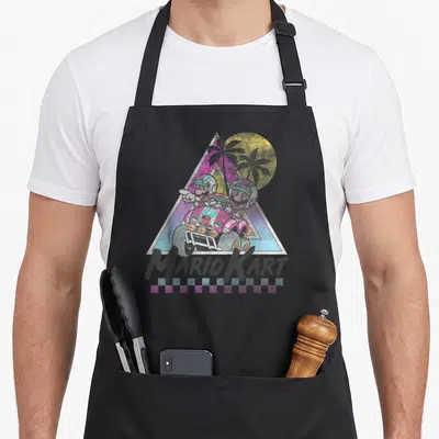 Trend novelty apron - Mario and Luigi in pink kart inside synthwave triangle with MARIO KART text and checkered border — shown on a black cotton canvas apron against a white background