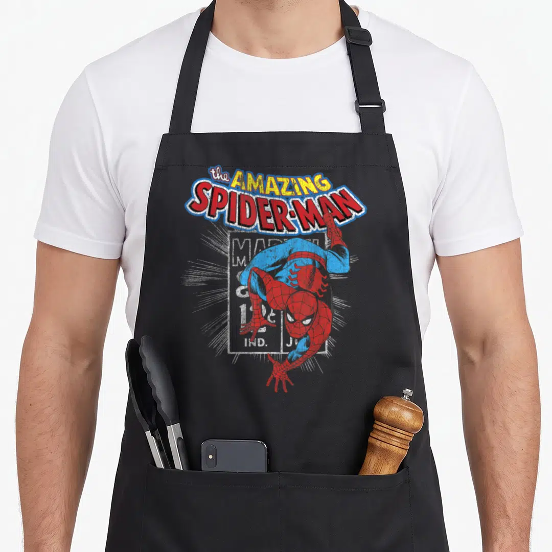 Amazing animal apron - Arched Amazing Spider-Man text above upside-down cartoon character in red blue yellow — shown on a black cotton canvas apron against a white background