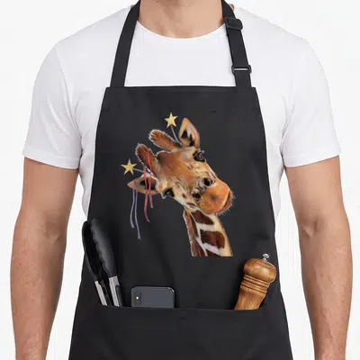 Drawing giraffe apron - Realistic giraffe head with two stars on wires and hanging red and purple ribbons — shown on a black cotton canvas apron against a white background