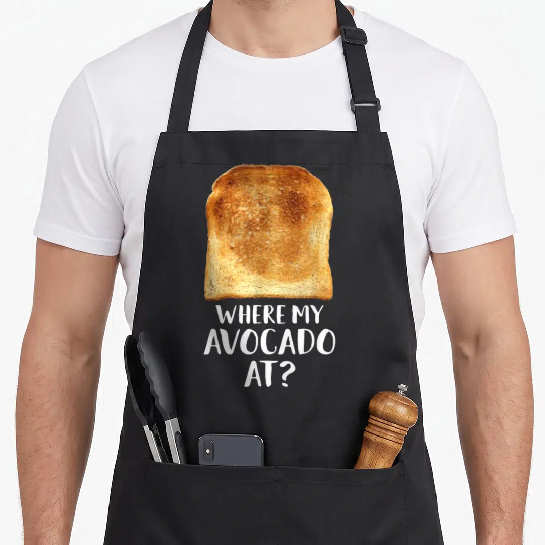 Delicious toast apron - Photo of golden toast above white text reading Where My Avocado — shown on a black cotton canvas apron against a white background