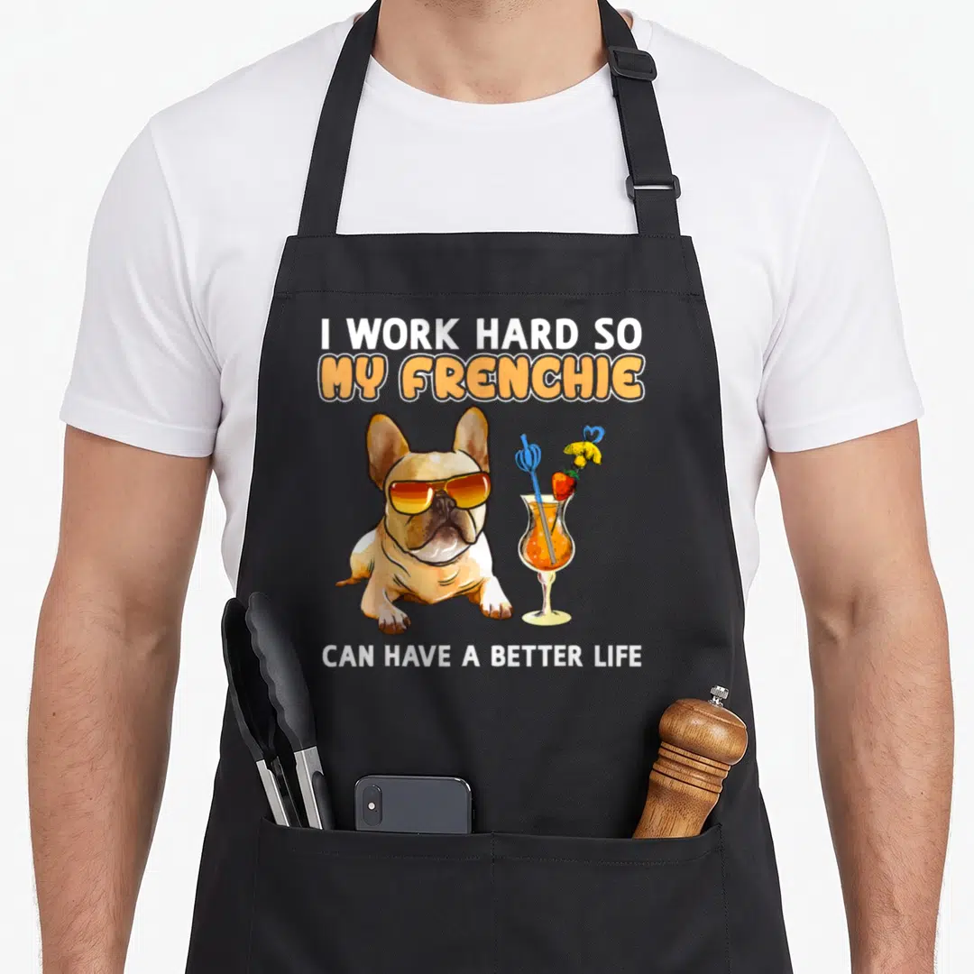 Frenchie bulldog french apron - Cartoon tan Frenchie with orange sunglasses next to an orange cocktail glass — shown on a black cotton canvas apron against a white background
