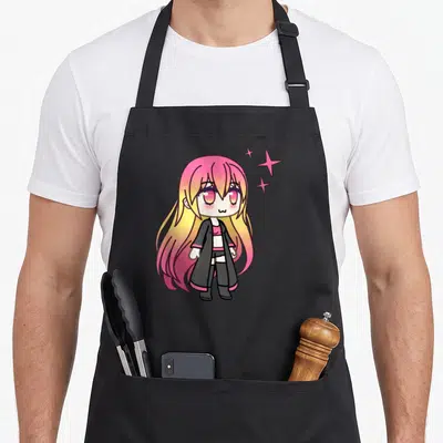 Zorya kawaii cooking apron - Chibi anime girl with pink yellow hair and three stars on black background — shown on a black cotton canvas apron against a white background