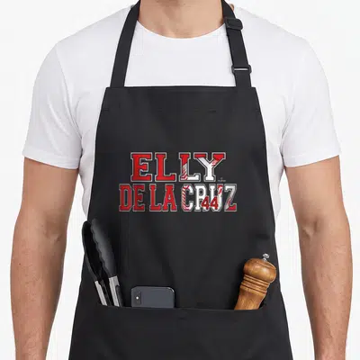 Elly cruz baseball apron - Red and white stacked text reading Elly De La Cruz 44 with baseball stitching in letters — shown on a black cotton canvas apron against a white background