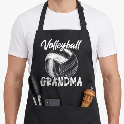 Volleyball family grandma apron - White line art volleyball centered between script Volleyball text and block GRANDMA — shown on a black cotton canvas apron against a white background