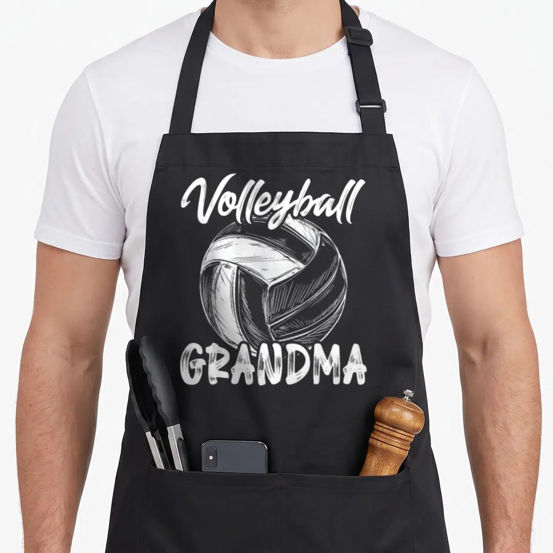 Volleyball family grandma apron - White line art volleyball centered between script Volleyball text and block GRANDMA — shown on a black cotton canvas apron against a white background