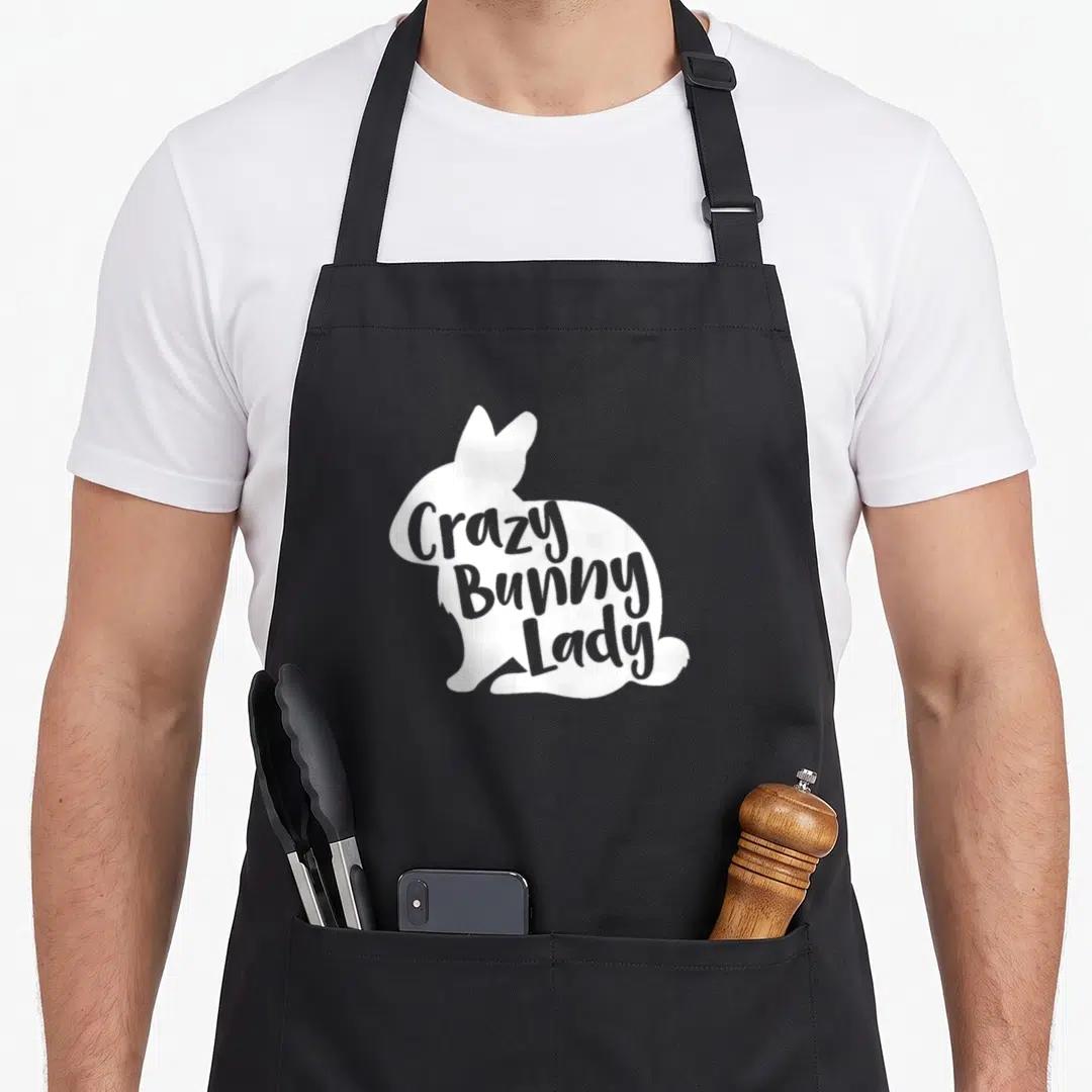 Cool rabbit bunny apron - White sitting bunny silhouette containing grey Crazy Bunny Lady text — shown on a black cotton canvas apron against a white background