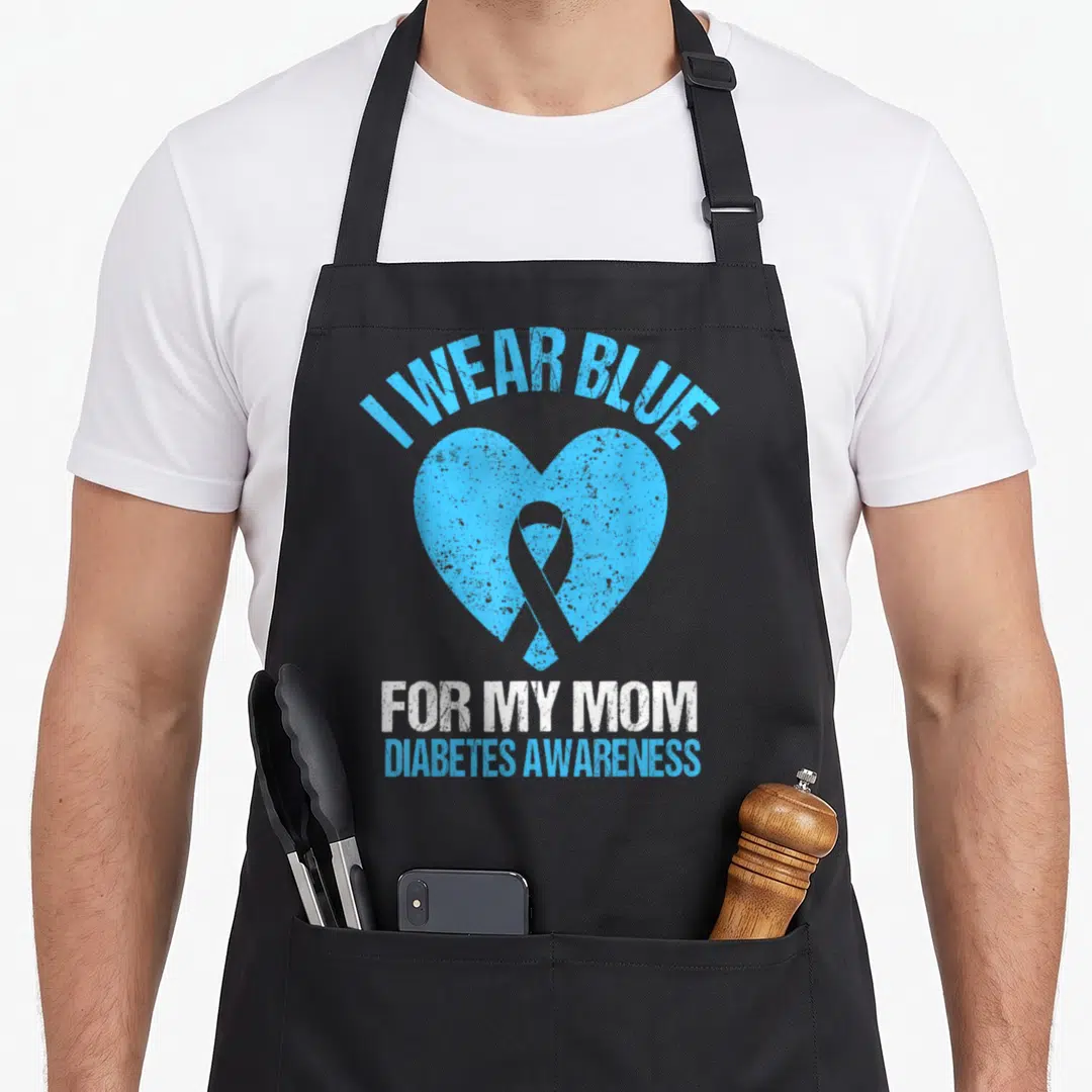 Blue support your apron - Distressed blue heart with ribbon and text I WEAR BLUE FOR MY MOM DIABETES AWARENESS — shown on a black cotton canvas apron against a white background