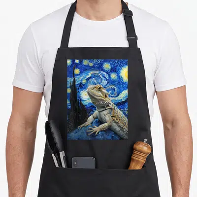 Bearded van gogh apron - Realistic bearded dragon against swirling blue starry night sky with cypress tree — shown on a black cotton canvas apron against a white background