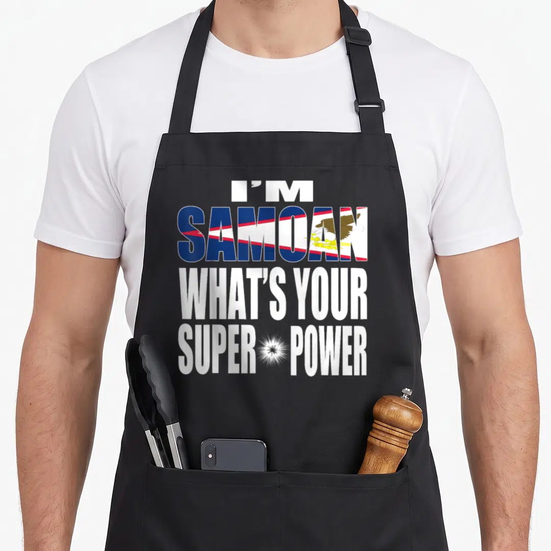 Culture samoa apron - Stacked white text I'M SAMOAN WHAT'S YOUR SUPER POWER with flag pattern eagle filling the word — shown on a black cotton canvas apron against a white background