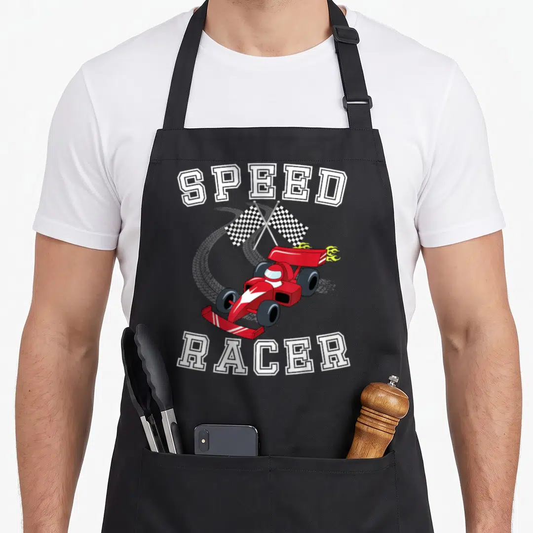 Formula car apron - Red cartoon race car with crossed black and white checkered flags and SPEED RACER text — shown on a black cotton canvas apron against a white background