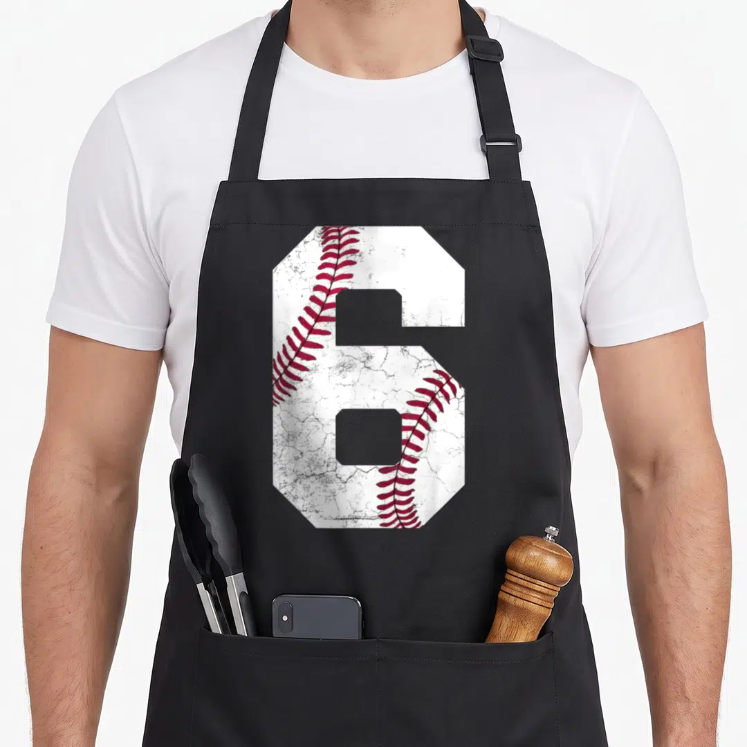 6th baseball apron - Large number 6 with baseball texture and red stitching on white background — shown on a black cotton canvas apron against a white background