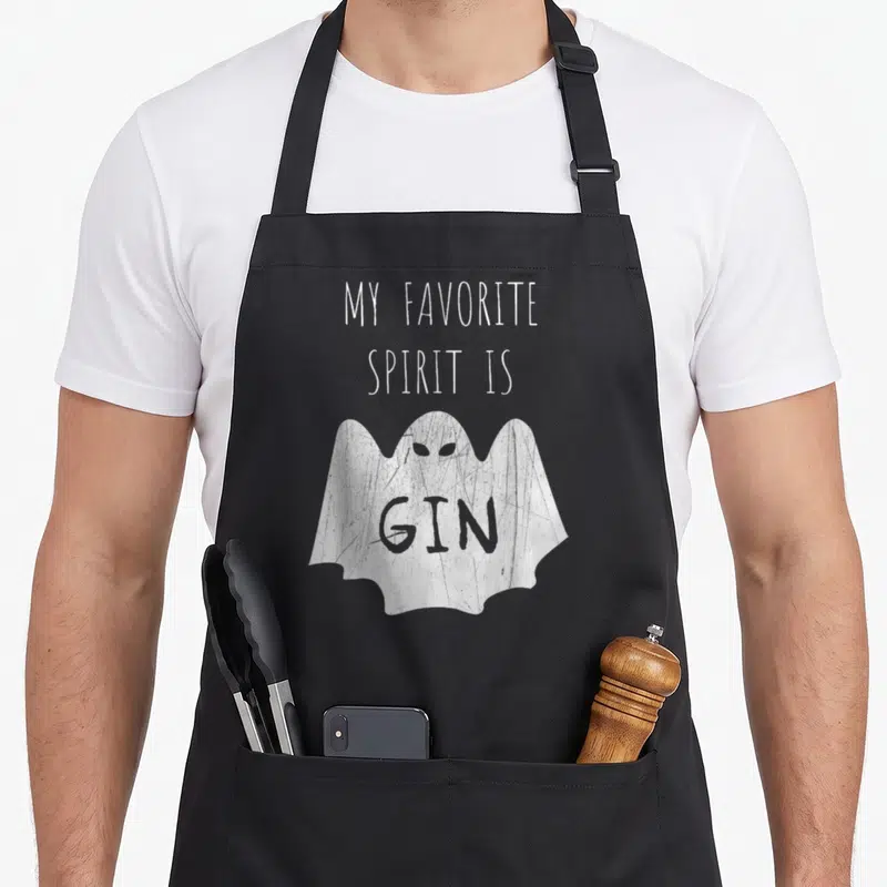 Food i love gin apron - White cartoon ghost with GIN on chest under My Favorite Spirit Is Gin text — shown on a black cotton canvas apron against a white background