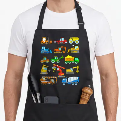 Excavator construction apron - Grid of 13 cartoon construction vehicles in yellow orange blue red and green — shown on a black cotton canvas apron against a white background