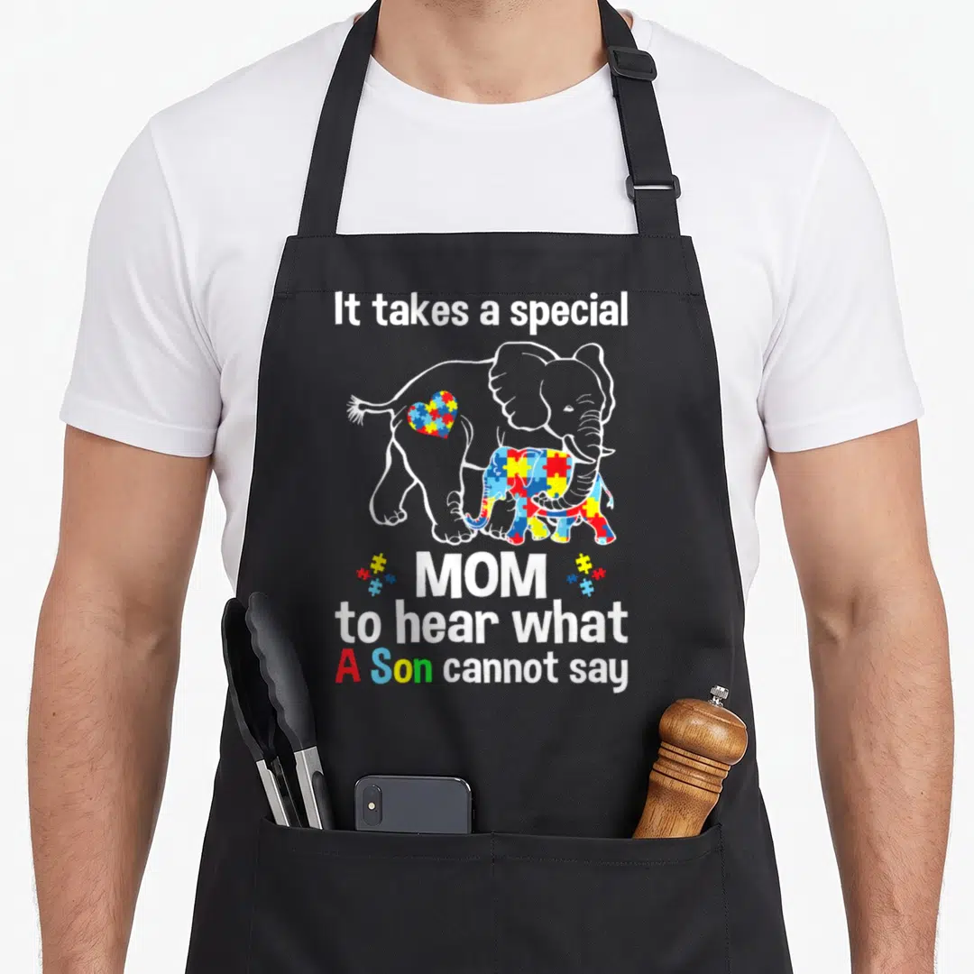 Special mom and son aprons - Elephant autism awareness apron with puzzle pattern and text about hearing what a son — shown on a black cotton canvas apron against a white background