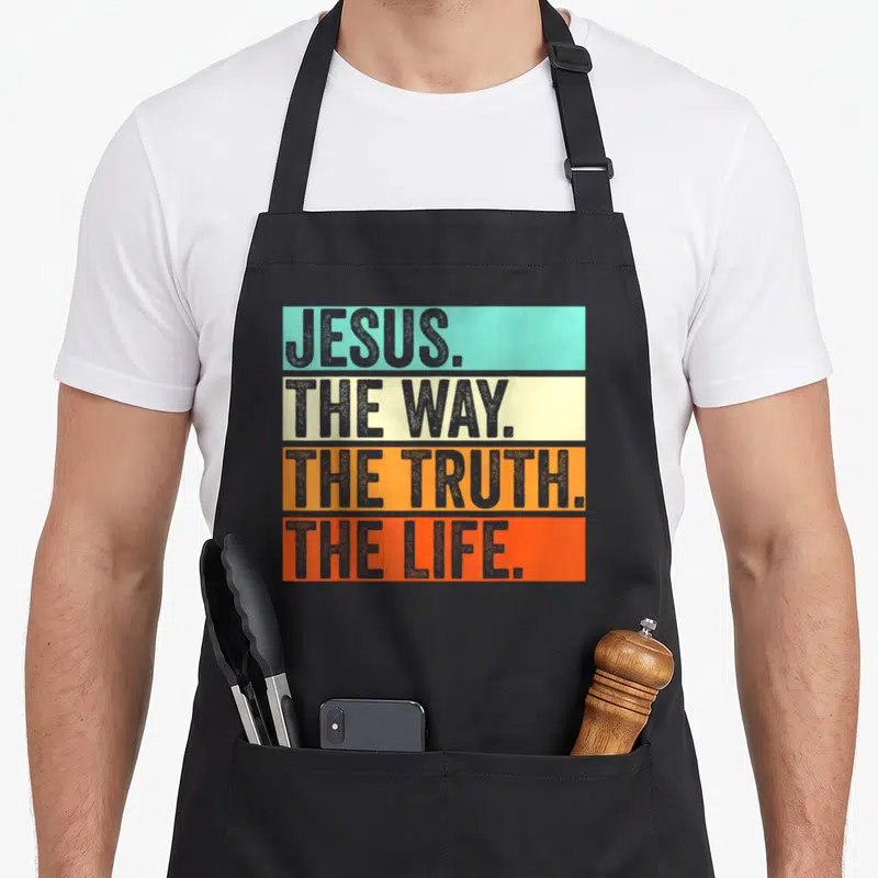 Worship bible verse apron - Stacked colored bars with JESUS THE WAY THE TRUTH THE LIFE in grey block letters — shown on a black cotton canvas apron against a white background