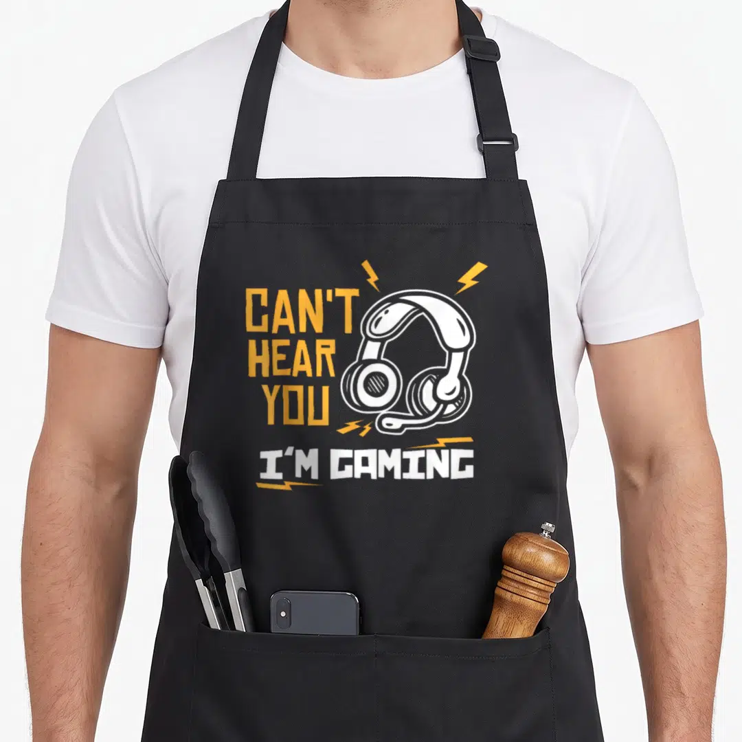 Hear gamer gaming apron - Orange and white text with cartoon headset and lightning bolts on gray background — shown on a black cotton canvas apron against a white background