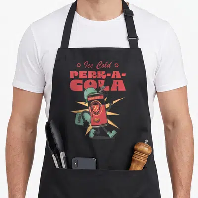 Ice video game apron - Walking soda can with helmet carrying bag and Ice Cold Perk-A-Cola text — shown on a black cotton canvas apron against a white background