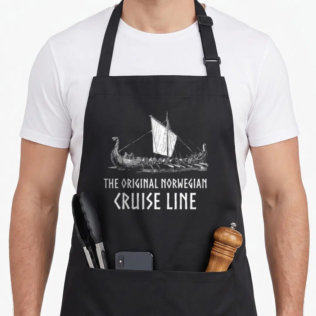 Ship viking apron - White line art viking ship above text reading THE ORIGINAL NORWEGIAN CRUISE LINE — shown on a black cotton canvas apron against a white background