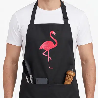 Funny pink flamingo apron - Minimalist pink flamingo standing on one leg centered on black fabric — shown on a black cotton canvas apron against a white background