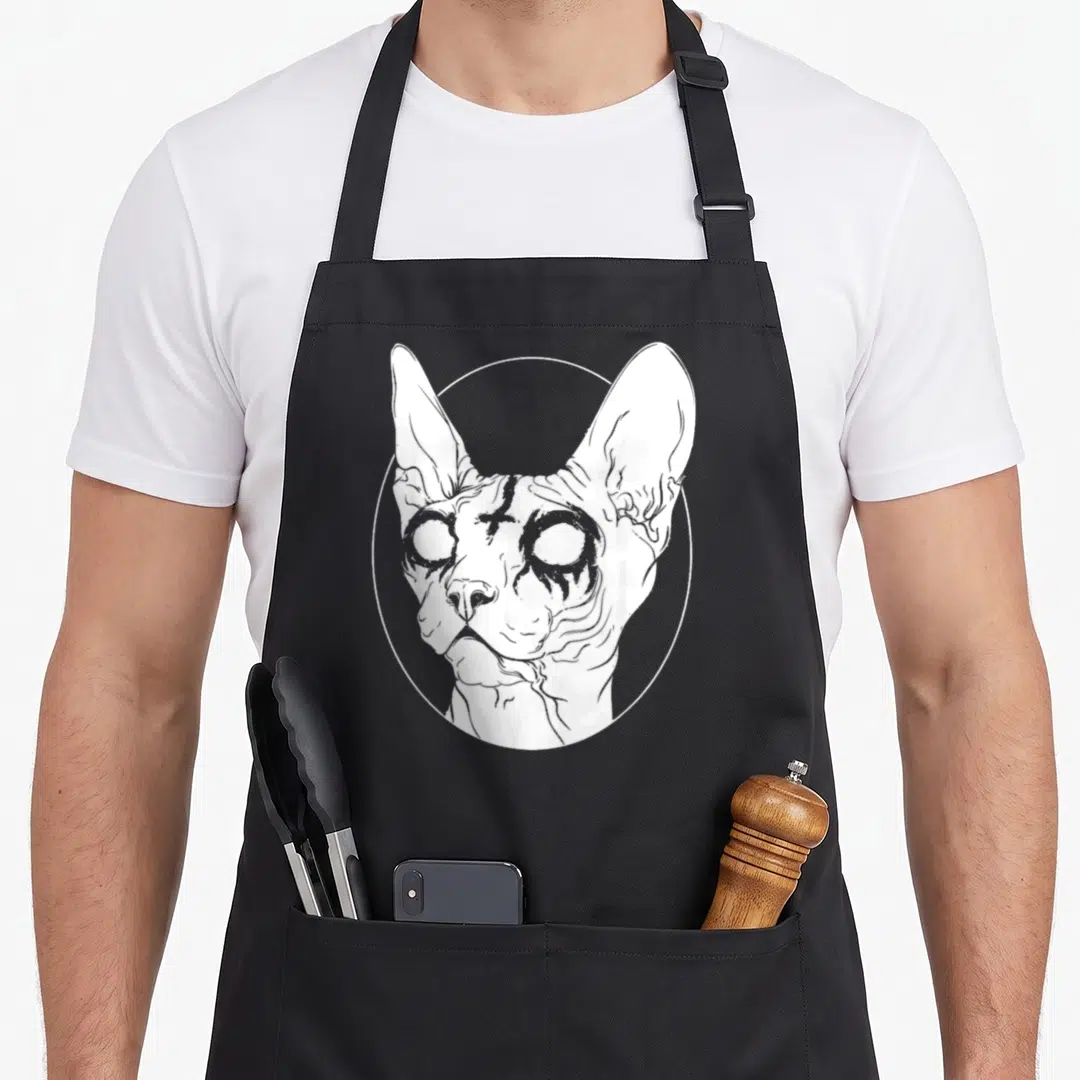 Metal cat apron - White line-art Sphynx cat head and shoulders inside a circular frame — shown on a black cotton canvas apron against a white background