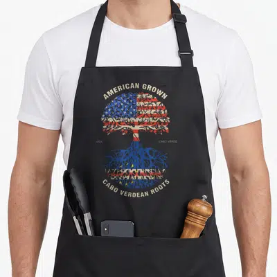 Verdean american flag apron - Retro tree design with US and Cabo Verde flag patterns and text — shown on a black cotton canvas apron against a white background