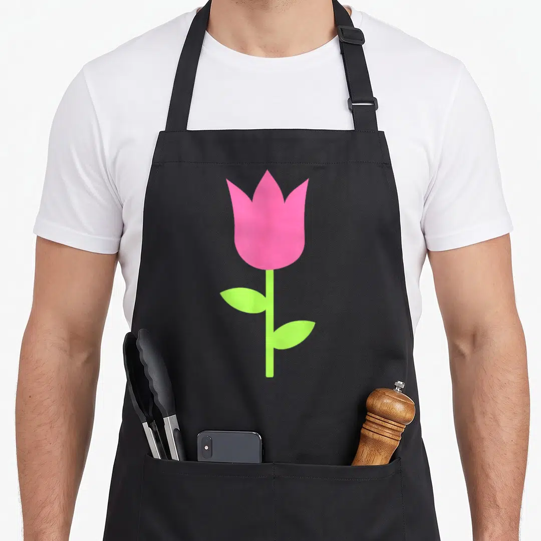 Funny tulip apron - Pink tulip flower with light green stem and two side leaves in cartoon style — shown on a black cotton canvas apron against a white background