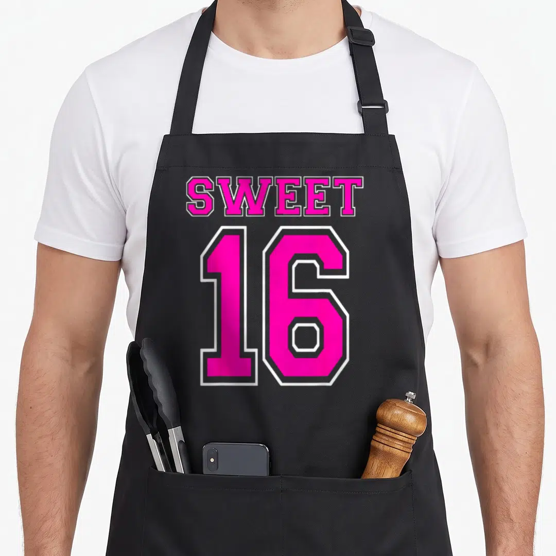 Sweet hot pink apron - SWEET 16 text in pink athletic font with white outline on black background — shown on a black cotton canvas apron against a white background
