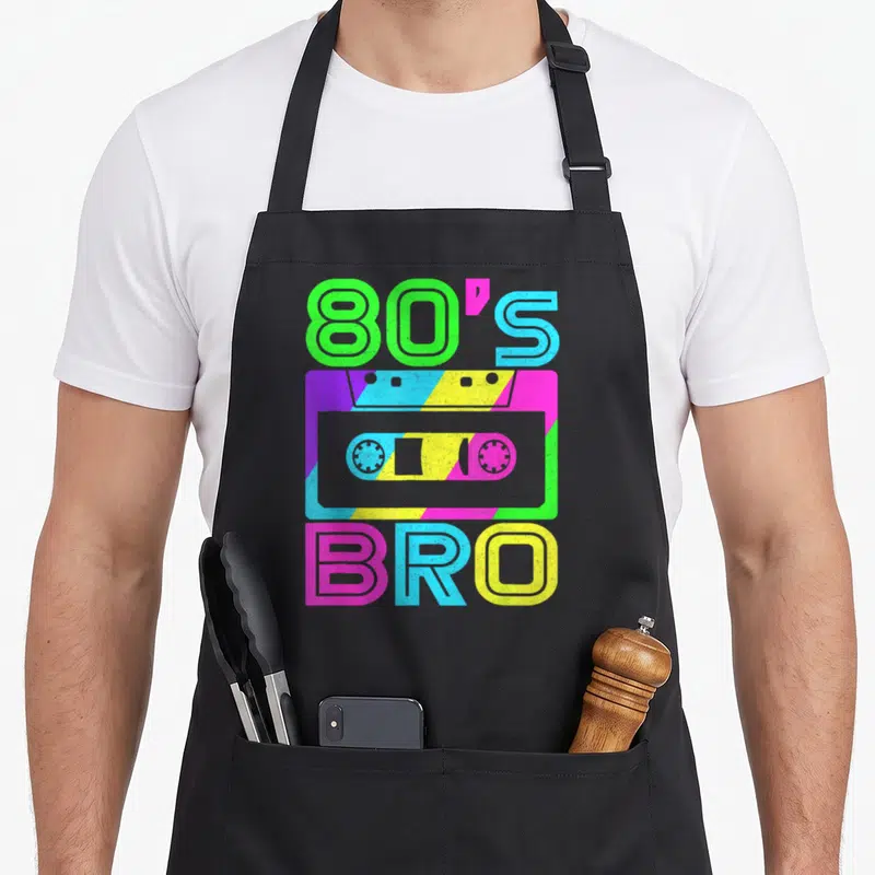Bro 80s apron - Neon cassette tape with 80'S BRO text on striped background — shown on a black cotton canvas apron against a white background