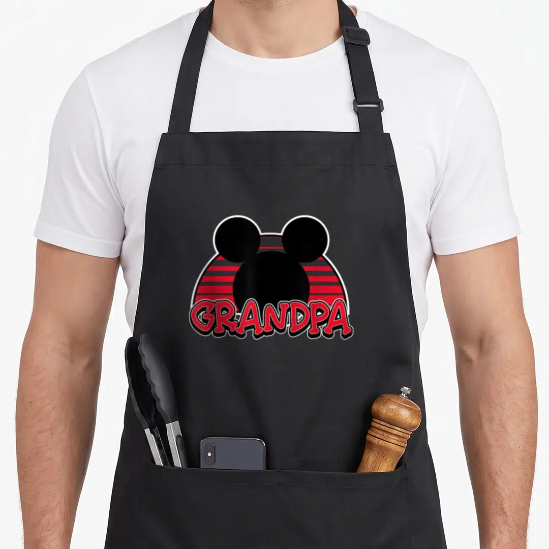 Funny grandpa apron - Black Mickey Mouse silhouette over red and black stripes with red GRANDPA text — shown on a black cotton canvas apron against a white background
