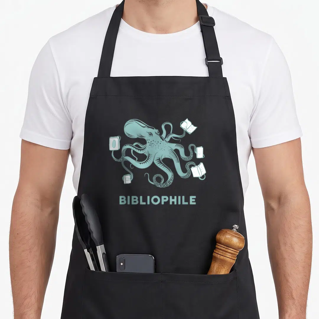 Octopus bibliophiles librarians apron - Muted teal line-art octopus surrounded by four white books with centered text — shown on a black cotton canvas apron against a white background