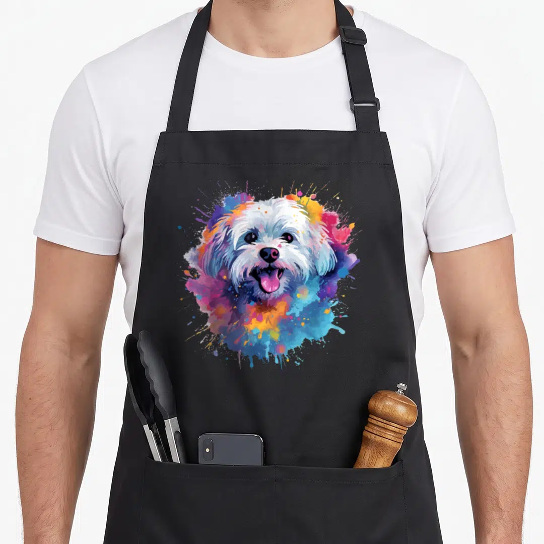 Colorful maltese dog apron - White Maltese dog head surrounded by blue pink and yellow watercolor paint splashes — shown on a black cotton canvas apron against a white background