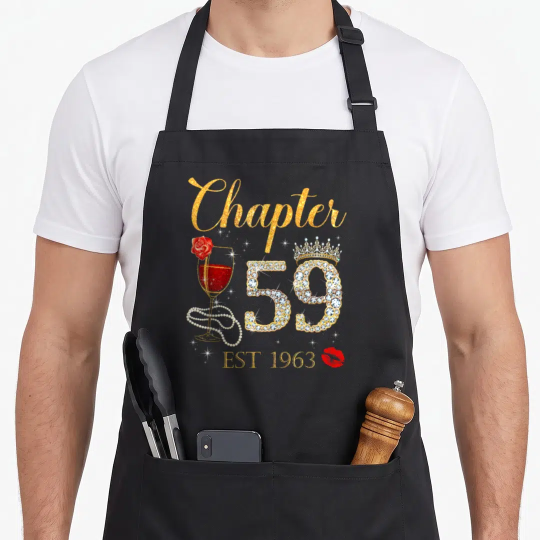 Chapter birthday apron - Gold Chapter text, rhinestone 59 with crown, red wine glass with rose and pearls, EST 1963 — shown on a black cotton canvas apron against a white background