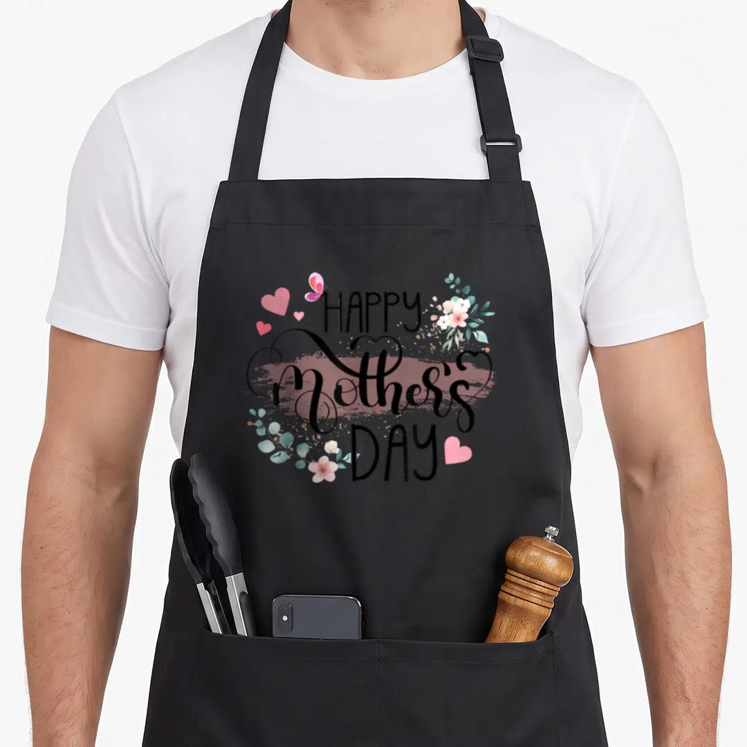 Floral grandma mother's day aprons - HAPPY Mother's DAY text in black over pink brush stroke with watercolor florals — shown on a black cotton canvas apron against a white background