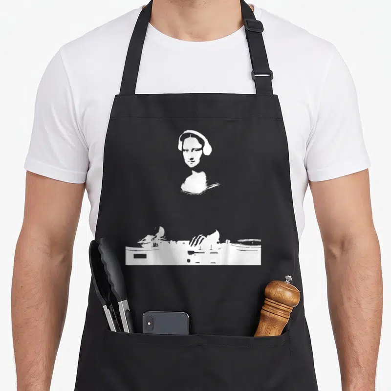 Edm mona lisa apron - White line-art woman with headphones above DJ controller and turntable on black background — shown on a black cotton canvas apron against a white background