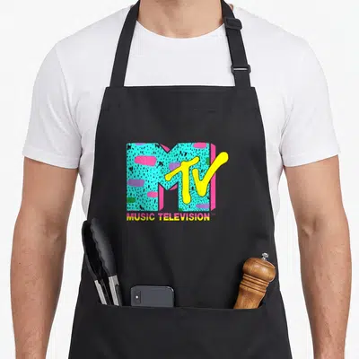 Mtv funky apron - Retro MTV logo with turquoise speckled M, yellow TV script, and MUSIC TELEVISION text below — shown on a black cotton canvas apron against a white background